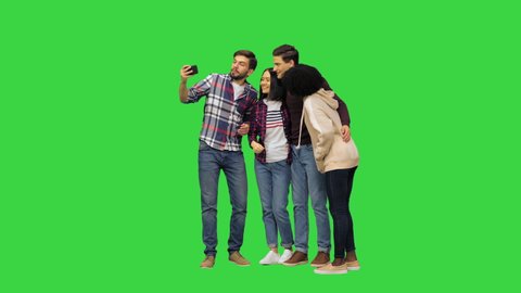 Wide shot. Front view. A group of cheerful students taking a selfie on a Green Screen, Chroma Key. Professional shot in 4K resolution. 042. You can use it e.g. in your medical, commercial video