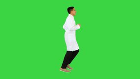 Wide shot. Side view. Running doctor in a robe calling for someone on a Green Screen, Chroma Key. Professional shot in 4K resolution. 070. You can use it e.g. in your medical, commercial video
