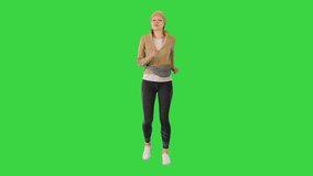 Wide shot. Front view. Woman fitness sport runner jogging outside on a Green Screen, Chroma Key. Professional shot in 4K resolution. 068. You can use it e.g. in your medical, commercial video, 