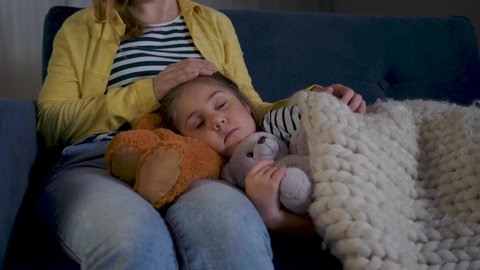 Sleeping baby with mom. Happy family. Baby girl sleeping with teddy bear toy. Mom waits for her daughter. Happy baby sleeping with toy teddy bear. Happy family taking care of children.