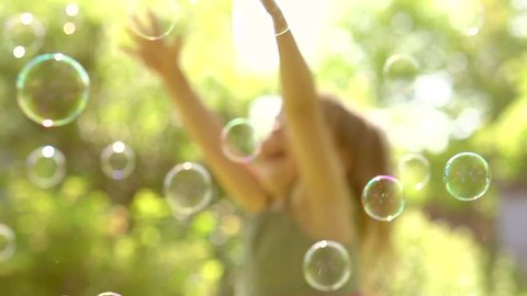 Happy Little Girl Playing wit Soap Bubbles outdoor, Laughing and Jumping. HD 1080p. Slow motion 240 fps, high speed camera 