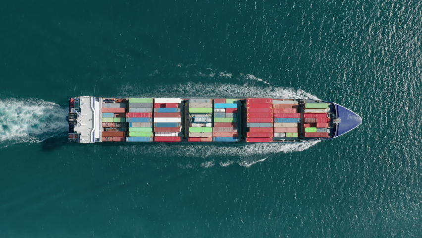 Aerial footage of a cargo ship sailing in open sea waters. Maritime transportation within the Atlantic Ocean. High quality 4k footage