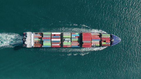Aerial footage of a cargo ship sailing in open sea waters. Maritime transportation within the Atlantic Ocean. High quality 4k footage