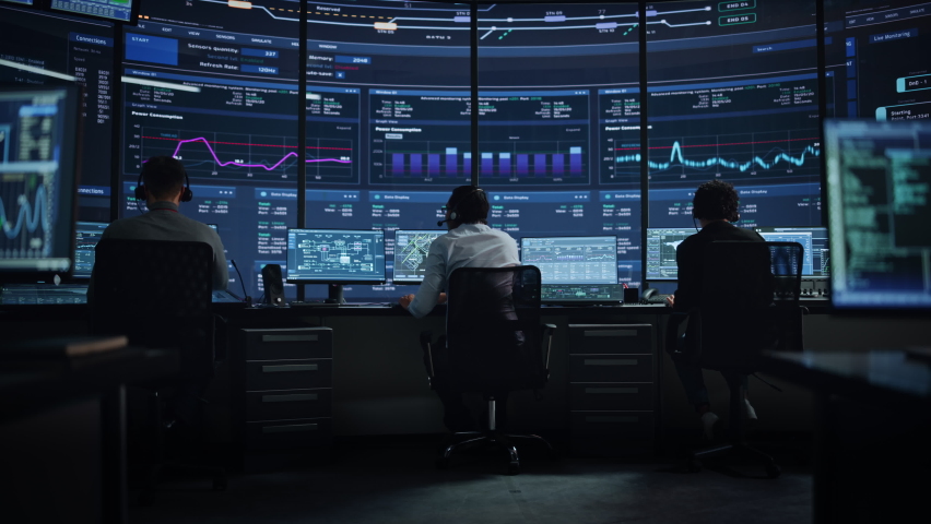 Professional IT Technical Support Specialists and Software Programmer Working on Computers in Monitoring Control Room with Digital Screens with Server Data, Blockchain Network and Surveillance Maps. Royalty-Free Stock Footage #1069211389