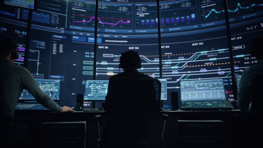 Professional IT Technical Support Specialists and Software Programmer Working on Computers in Monitoring Control Room with Digital Screens with Server Data, Blockchain Network and Surveillance Maps. Royalty-Free Stock Footage #1069211434