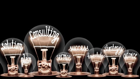 Light bulbs going from dark to light with Consulting, Solution, Strategy, Success and Knowledge fiber text on black background. High quality 4k video.