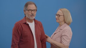 The old woman says naughty things in her husband's ear. Beautiful elderly couple laughing together a lot. Concept of having fun together. - Powered by Shutterstock - Get 15% off with code: PIKWIZARD15