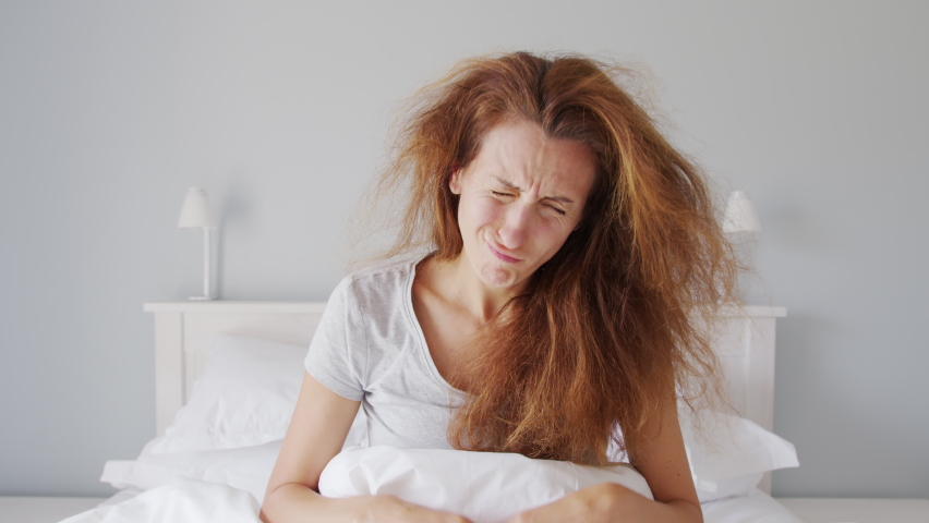 A girl wakes up nin bad in the morning and feels tired, lackof sleep and laziness. | Shutterstock HD Video #1069232515