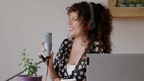 Smiling female content creator streaming at home. Record a podcast