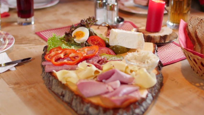 Bread, cold cuts, cheese on a typical austrian snack time board. | Shutterstock HD Video #1069235161