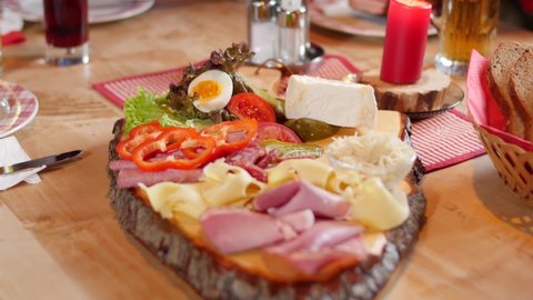 Bread, cold cuts, cheese on a typical austrian snack time board.