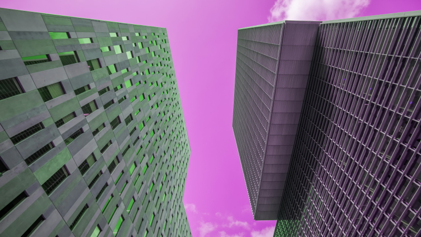 Timelapse of clouds moving above generic skyscrapers and towers in Barcelona