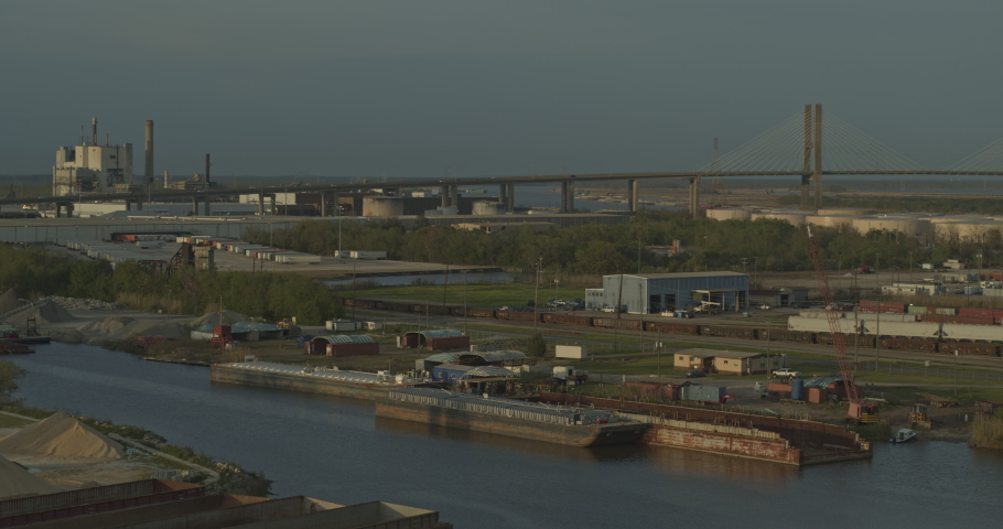 Mobile Alabama Aerial v10 Flying low over industrial trainyard area with cityscape views at sunset - Shot with Inspire 2, X7 camera. March 2020