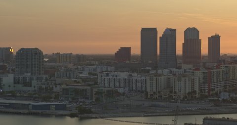 Tampa Florida Aerial v47 pan right shot of bright, yellow sunset behind city skyline shot with Inspire 2, X7 camera March 2020.