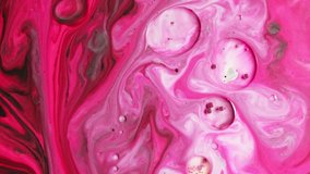 Macro shot of fuchsia pink and white blended together to form an abstract living canvas. Concept of trending effects and contemporary art in videos