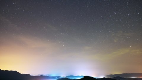 Стоковое видео: Amazing Starry night in mountains Time lapse.Milky way galaxy stars moving over Mountain countryside with fog flowing on high mountain Night to day Timelapse seen in Phangnga Thailand Beautiful Nature