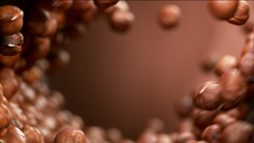 Super slow motion of flying hazelnuts in rotating movement. Filmed on high speed cinema camera, 1000fps. Royalty-Free Stock Footage #1069254529
