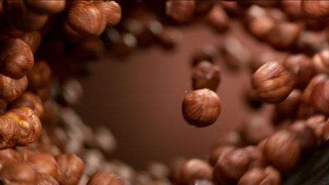 Super slow motion of flying hazelnuts in rotating movement. Filmed on high speed cinema camera, 1000fps.