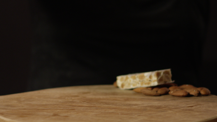 Hard nougat pieces falling on a board Royalty-Free Stock Footage #1069258540