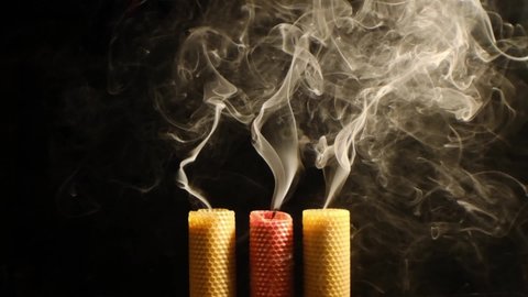 Three candle goes out and smokes. Slow motion