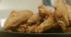 Closeup of fried chicken wings. Slider shot. Shot in 4K on a cinema camera.