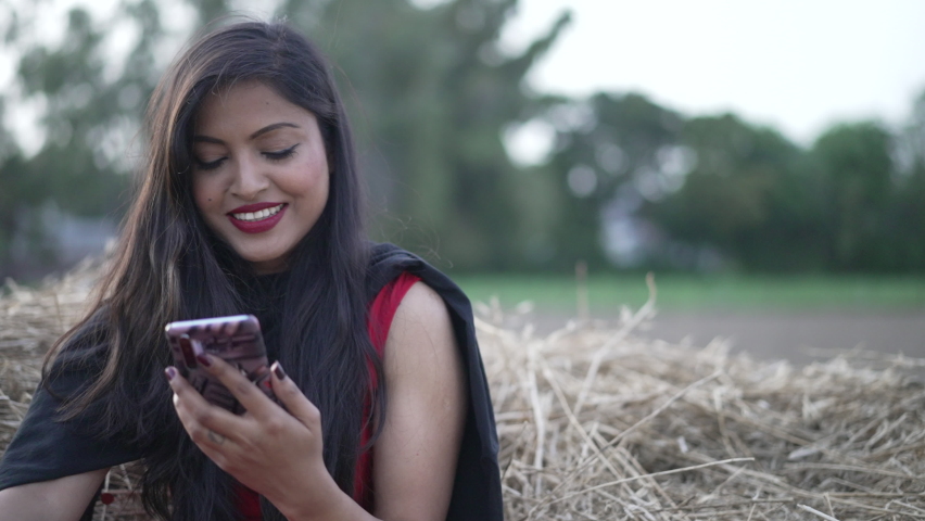 Indian village girl walking in greenfield wearing Indian traditional Suit. Walking in the agricultural field. High-quality 4k footage