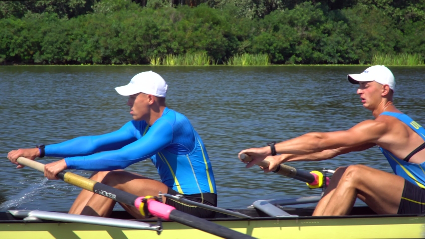 Rowing team summer training. 8 athletes rowers in a boat in the river Dnipro. City area in Kiev, Ukraine. Go Everywhere! Be H3althy Royalty-Free Stock Footage #1069268404
