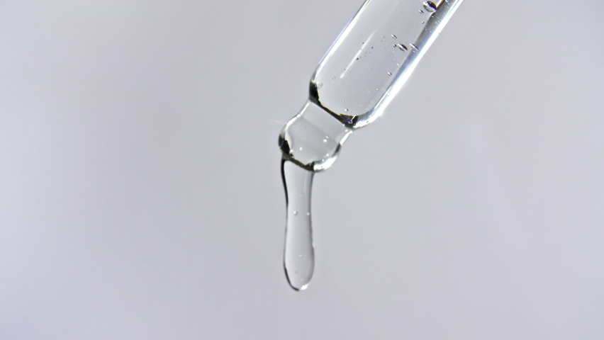 Cosmetic pipette with drops of oil close up on gray background | Shutterstock HD Video #1069275736