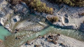 Drone video of rocky mountain river shot directly above it.