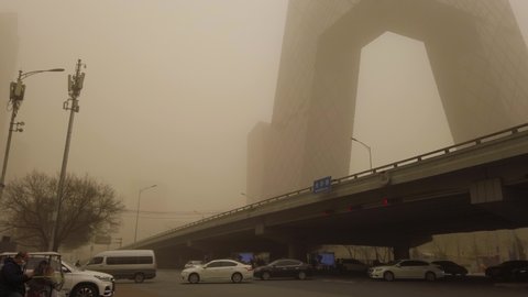 Beijing, China - Mar15, 2021: Sky turning orange as sandstorm and pollution hitting the city.