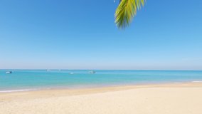 4k cinemagraph b-roll footage video, Cyan blue sea water surface n calm ocean wave crashing golden sandy beach with boat ship n exotic palm tree leaf on sunny clear blue sky n white wispy smoke clouds