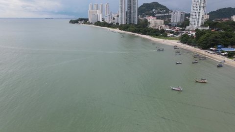 Aerial view of fishing boats, sea, beach and apartment in Tanjung Bungah. Tanjung Bungah is one of the attraction in Penang Island.