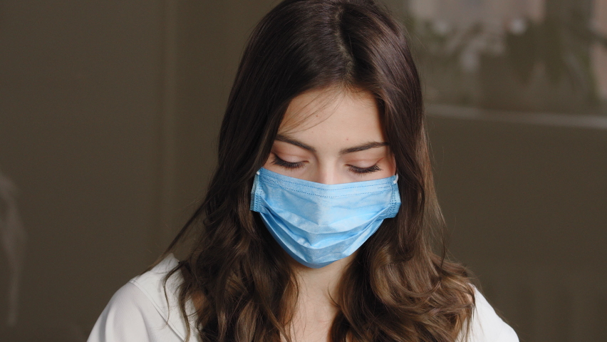 Portrait of beautiful brunette woman patient girl takes off protective medical mask from female face throwing away, smiles sincerely rejoices end of pandemic, enjoying air breathing, looking at camera Royalty-Free Stock Footage #1069297858