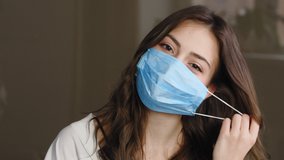 Portrait of beautiful brunette woman patient girl takes off protective medical mask from female face throwing away, smiles sincerely rejoices end of pandemic, enjoying air breathing, looking at camera - Powered by Shutterstock - Get 15% off with code: PIKWIZARD15