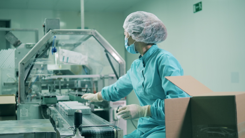 Female health worker packing medicines. Drugs production, pharmacist working, pharmaceutical manufacturing, pharmaceutical industry concept. Royalty-Free Stock Footage #1069303324