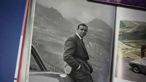 Rome, Italy - March 15, 2021, biography of publisher Taschen with photos of Sean Connery next to the famous and original James Bond 007 Aston Martin.