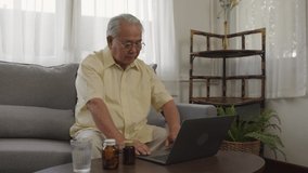 Asian older man patient having video chat with doctor about how to take pills on tablet computer at home.Technology,Healthcare, Innovation, Well-being, Care, Strength, Fitness and Vitality,Medical