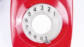 A stop motion shot of a red classic rotary telephone zooming in and out - Powered by Shutterstock - Get 15% off with code: PIKWIZARD15