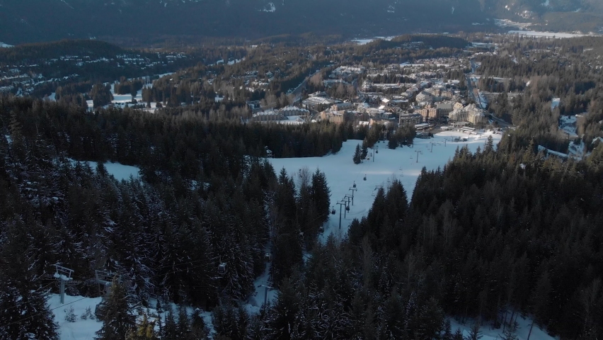 Aerial view of Whistler Village and ski runs at sunset. 4K 24FPS.