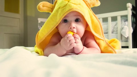 Baby after bathing in a towel. Selective focus. People.