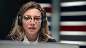 Stylish business lady in headset talking webcam video call use laptop service application at office. Entrepreneur female consulting online conference teaching e learning. Closeup shot on 4k RED camera
