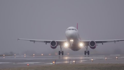 Airplane (aircraft) takes-off (taking off) on a foggy day
