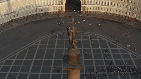 Aerial view of Palace Square and Alexander Column at sunset, The angel with cross, The drone falls down the Winter Palace, the Hermitage, triumphal chariot, little people walks