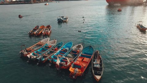 Aerial drone shot over the fishing port of san antionio Chile, around local artisanal fishing boats aerial video concept and industry