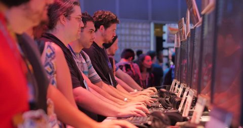 LOS ANGELES - June 17: Gamers testing demo video games at E3 2015 expo. Electronic Entertainment Expo, commonly known as E3, is an annual trade fair for the video game industry. 4K UHD