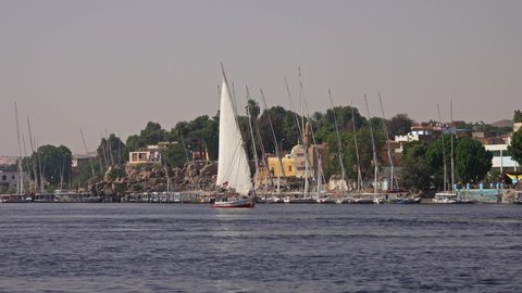 Egyptian felucca boat sailing along the Nile River in Aswan