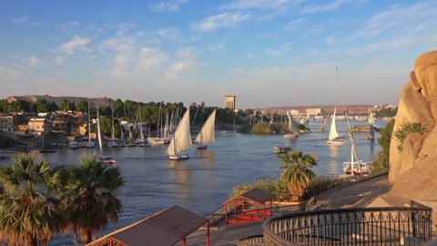 Beautiful landscape with felucca boats on Nile river in Aswan at sunset, Egypt, timelapse 4k