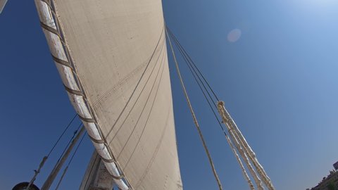View from below on white sail of felucca boat in Egypt, 4k