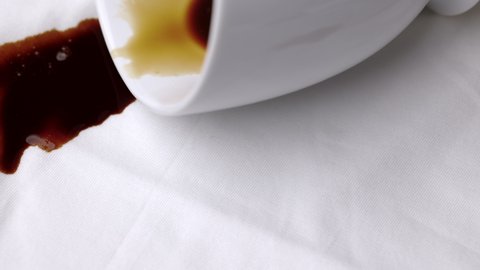 Spilled hot coffee mugs on a white shirt. A white cotton shirt stained with brown coffee