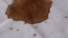 Coffee drop on the shirt. A white cotton shirt stained with brown coffee - Powered by Shutterstock - Get 15% off with code: PIKWIZARD15